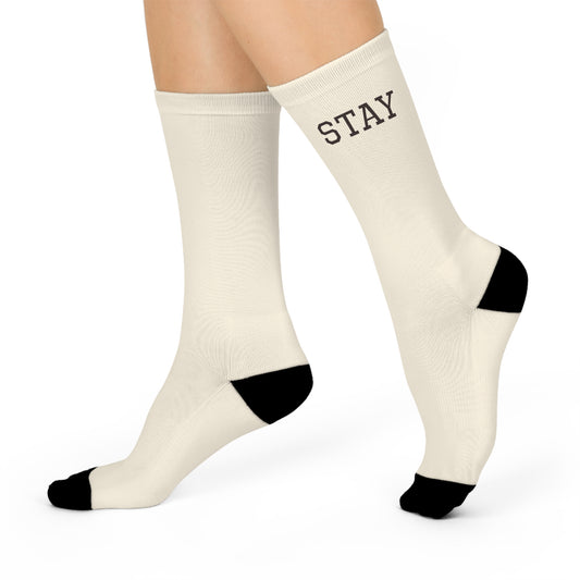 Sunday Archive Stay Home Socks in ivory with contrast black heel and toe, shown on feet with the word STAY printed on one sock